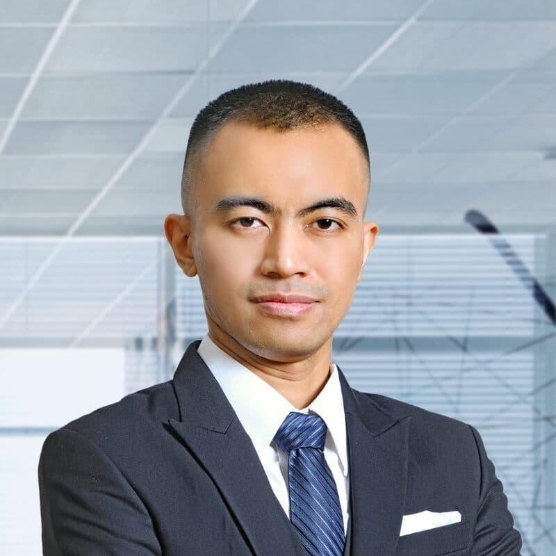 Ade Hidayat | Kompacity Solutions Leadership Portrait of Ade Hidayat, Founder of Kompacity Solutions, in formal business attire including a dark suit, white pocket square, and blue tie.